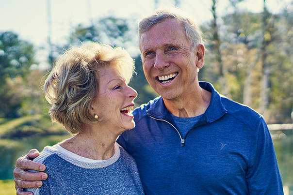 Older couple outside smiling