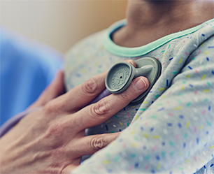 doctors hand checking a heart beat of a patient